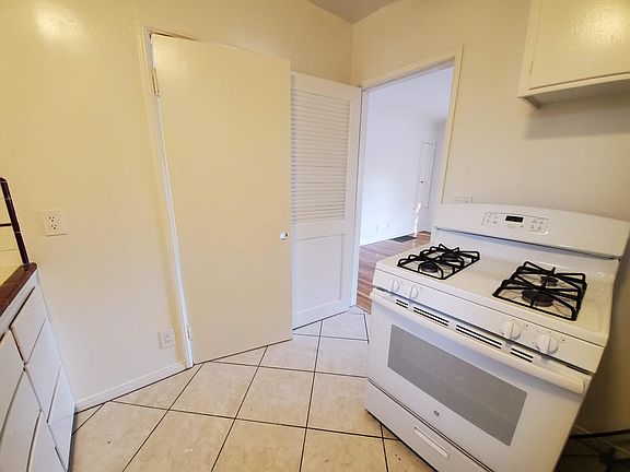Kitchen, gas stove, the door on the left leads to the dining room