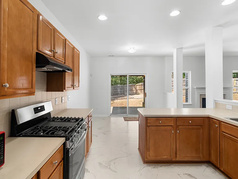 Kitchen features new gas stove.