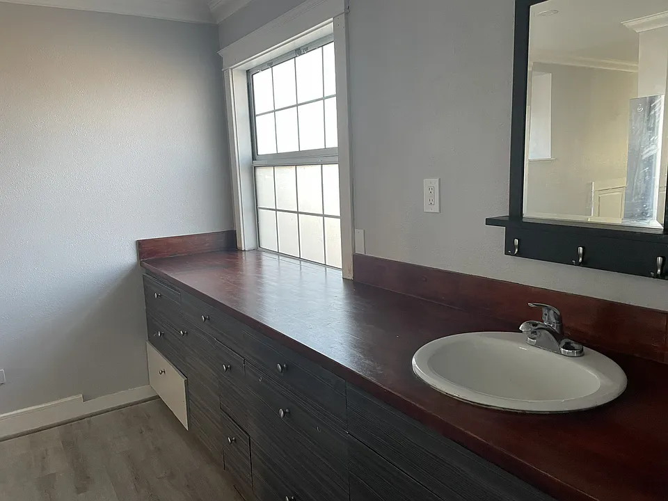 Counter for two burner hot plate. Also sink for bathroom washing hands etc.