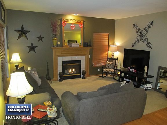 Tile surround gas lit fireplace with newer detailed mantle