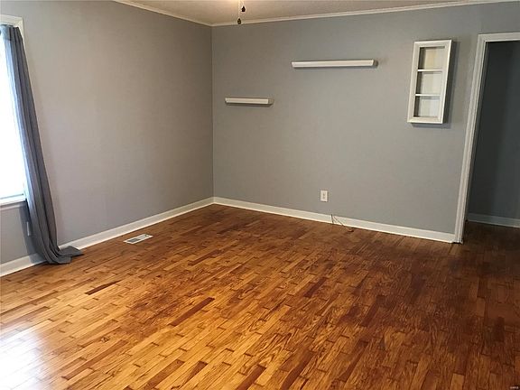 Living room from entrance door with original wood floor