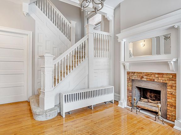 Victorian charm galore: high ceilings, maple floors, elaborate woodwork and a stunning decorative fireplace