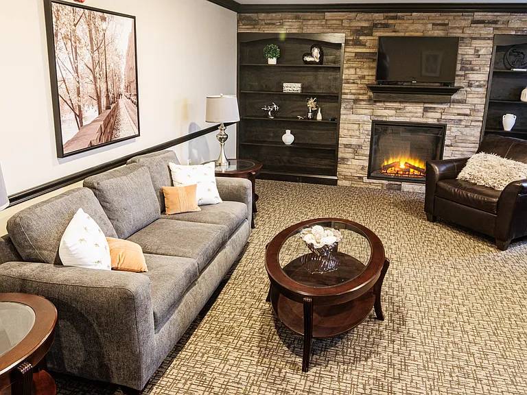 Warm and inviting gathering space with a fireplace, comfortable seating, and a welcoming community atmosphere