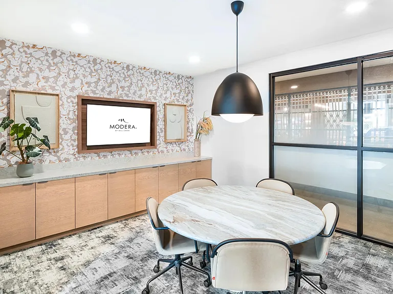 Polished conference room at Modera Higley Commons, offering a refined setting with thoughtful design for collaboration and connection.