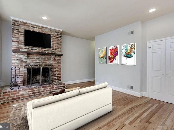 Living room. Bay windows (not shown) add a lot of light and are a great place for a dining or office table.