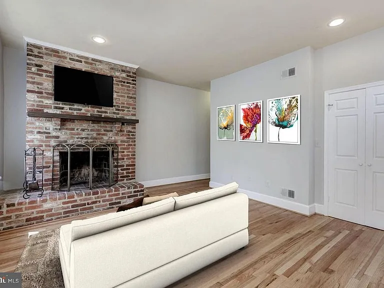 Living room. Bay windows (not shown) add a lot of light and are a great place for a dining or office table.