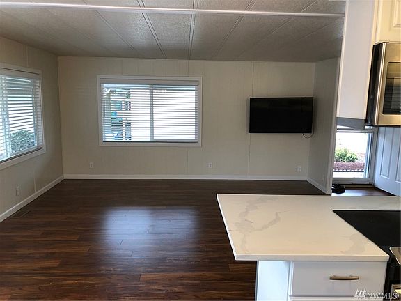 Custom laminate wood flooring throughout the kitchen,dining room, living room, hallway.
