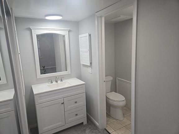 THis is the half bath in the rear bedroom. Laundry is in this room also