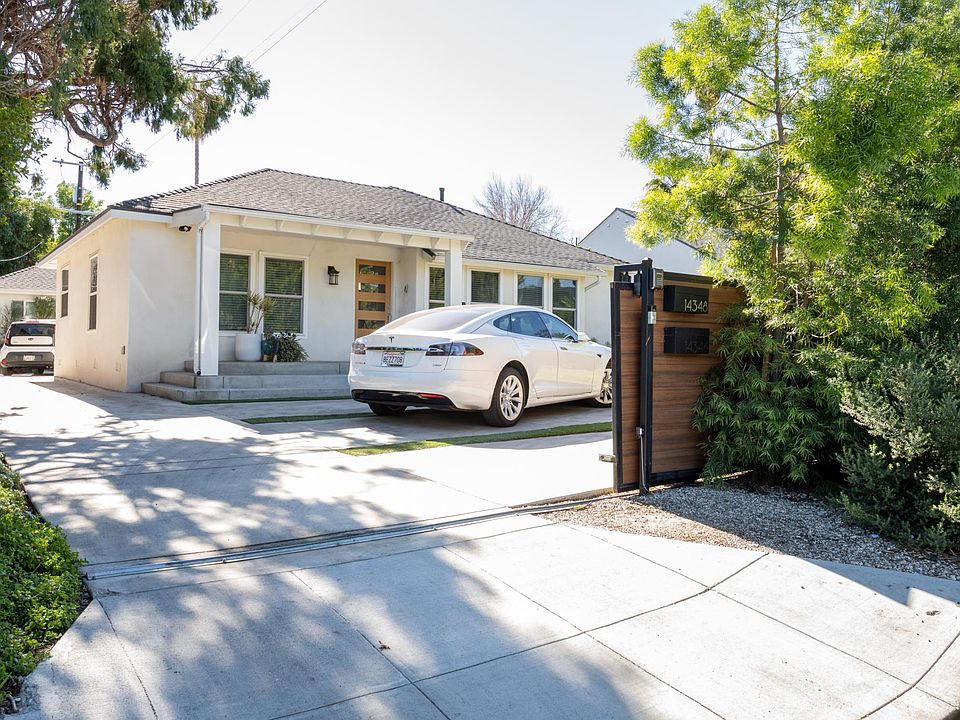 Gated driveway accommodates two vehicles and includes a Tesla charger_offering added security, convenience, and modern functionality.