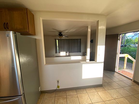 Looking from the kitchen/dining area into the living room (unfortunately the curtains are covering the windows and the view)
