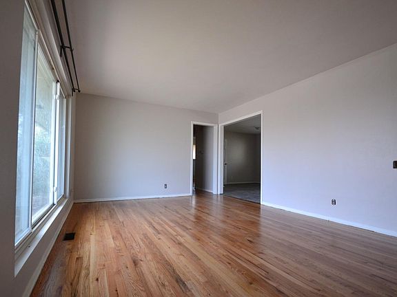 Living room with huge picture window and hardwood floors