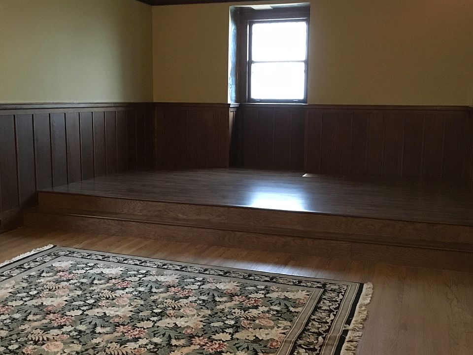 View of massive living room empty of furniture. Has doomed ceiling
