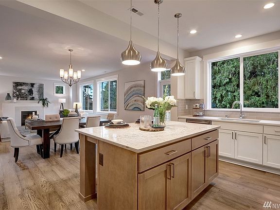 Kitchen with adjoining dining area and great room with access to an spacious deck