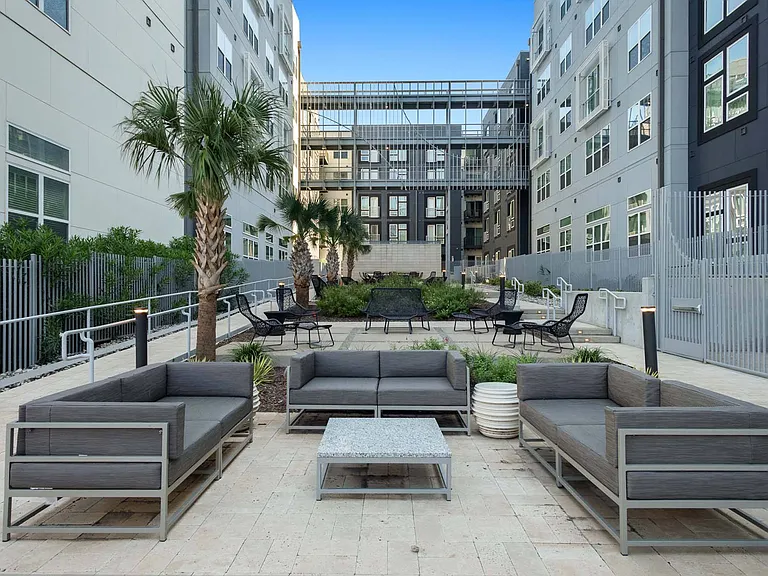 Gather with friends or unwind solo on the comfortable courtyard couches, ideal for enjoying the fresh air.
