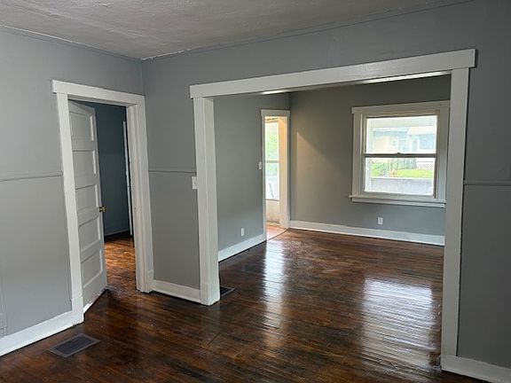 Front door and living room leading into the dining room.