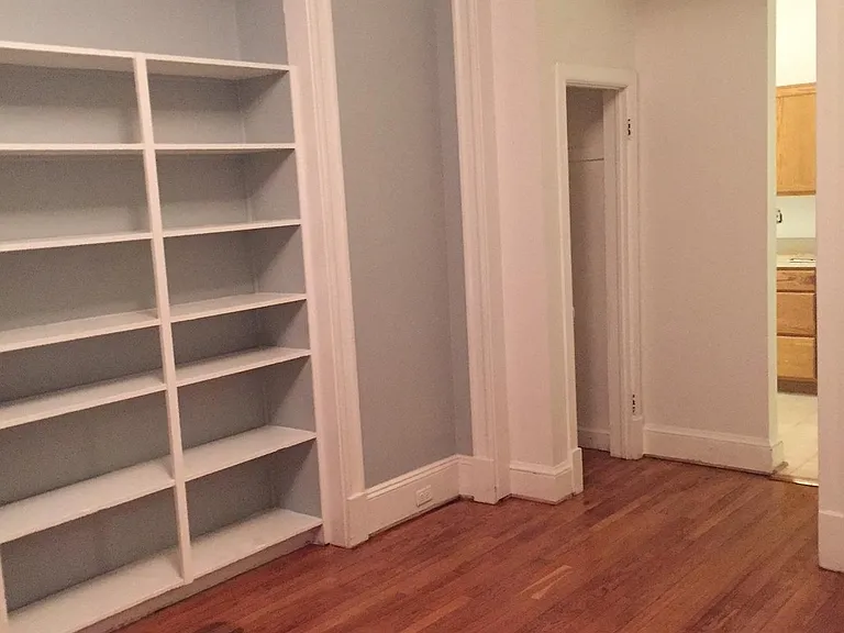 Another photo of built in bookshelves and closet in front living room looking toward kitchen.