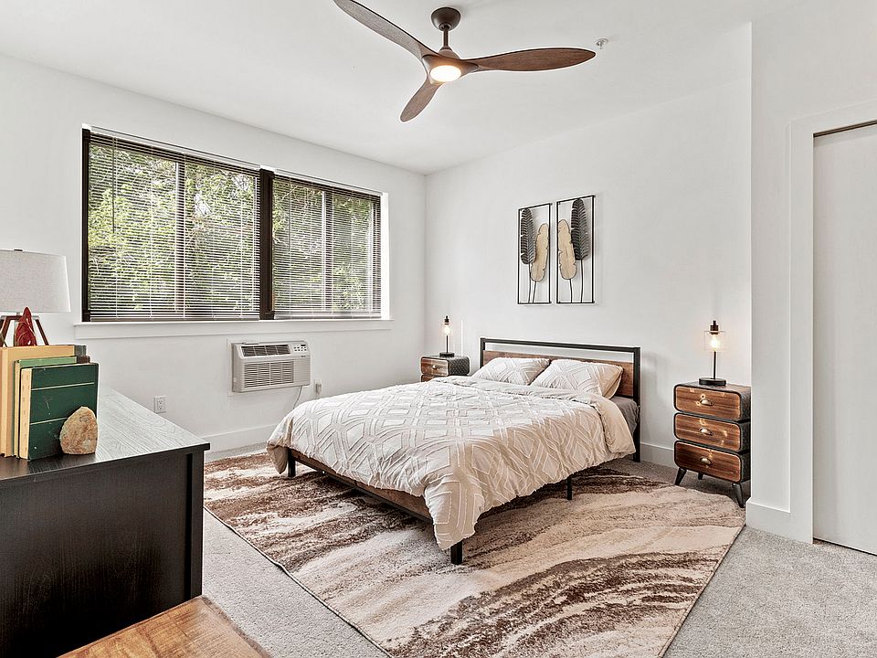 Experience tranquility in this beautifully designed bedroom with elegant furnishings and natural light.