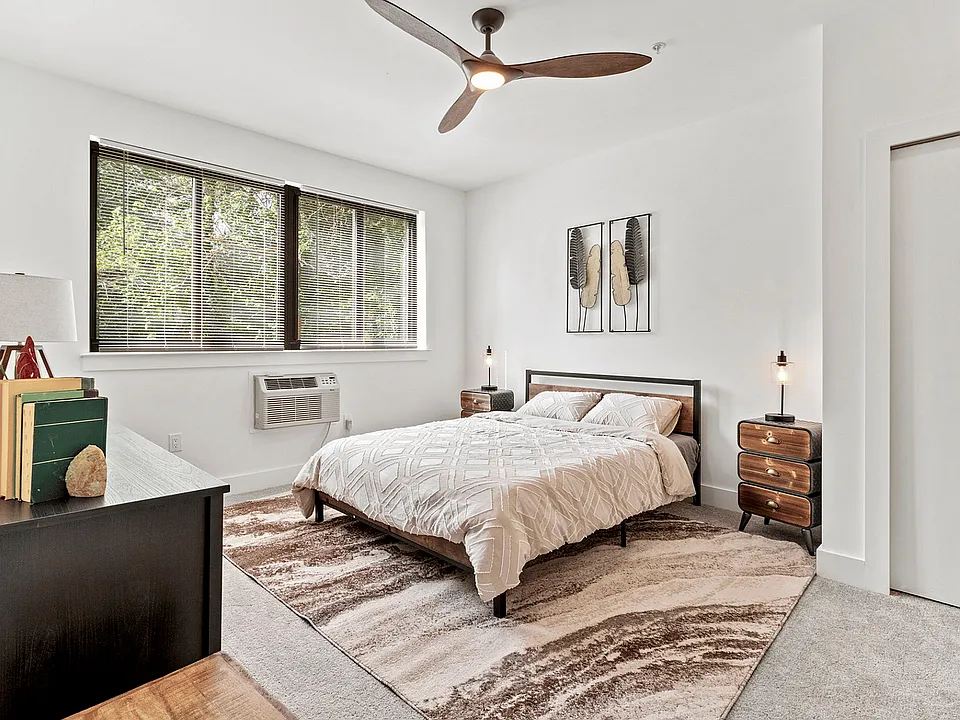 Experience tranquility in this beautifully designed bedroom with elegant furnishings and natural light.