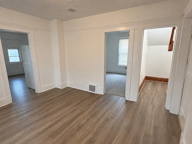 Shared living area - to left entrance to kitchen, straight ahead bedroom 1 and hall way to the foyer and stairs