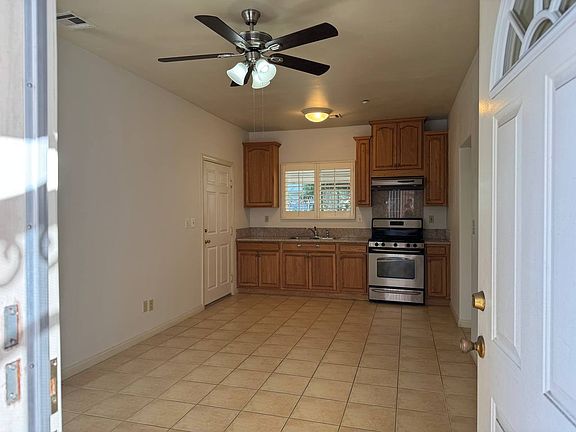 Living room and kitchenette, looking in through front door