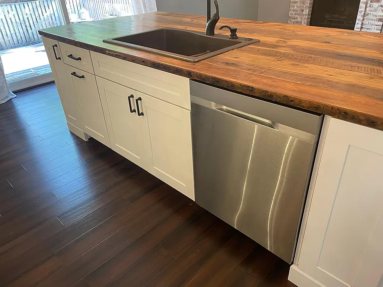 Dishwasher and plenty of cabinet storage on island & trash bin built in