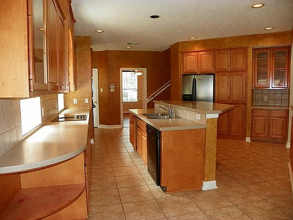 The kitchen in this house is BIG!  The island is home to the cooktop and a breakfast bar.