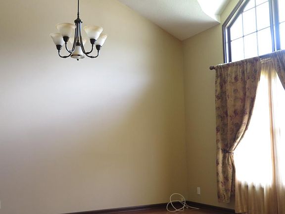 Spacious living room has high ceiling and big windows