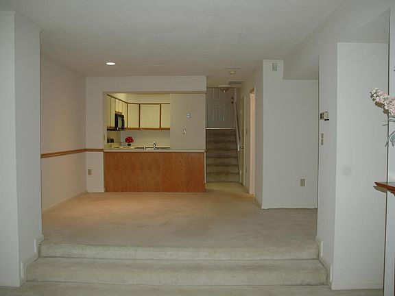 View of dining room, kitchen and steps to front door from li