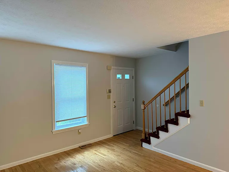 Front door into living room, stairs to second floor