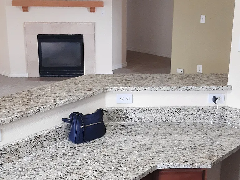 Open concept space flows from the kitchen to the bar space to the living room. Vaulted ceilings gives that space an abundant and relaxing feel.
