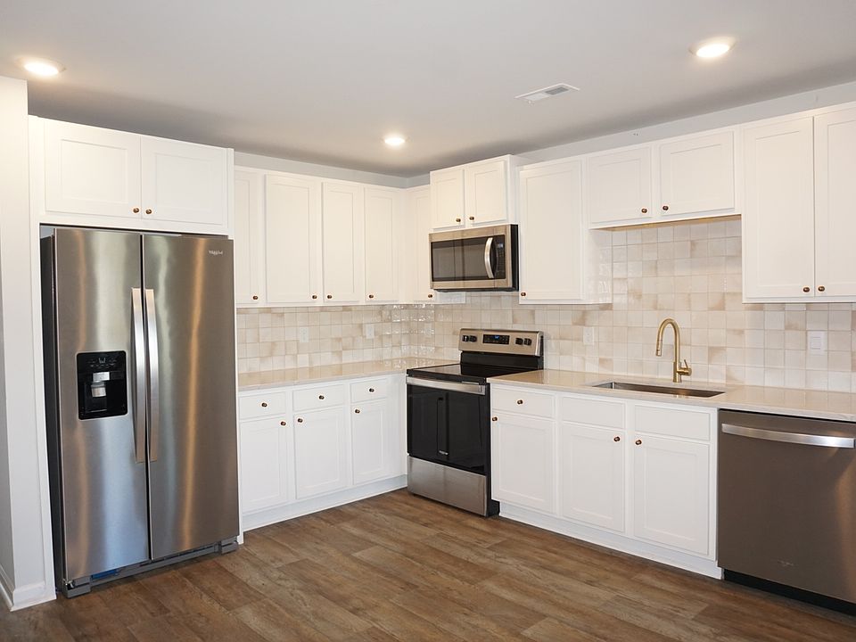 Updated kitchen with quartz countertops and stainless steel appliances
