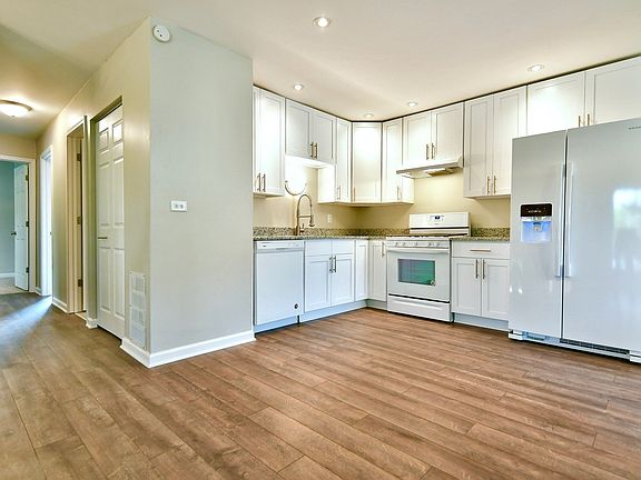 Newly done kitchen featuring granite counter tops, new shaker style cabinets, and brand new applianc