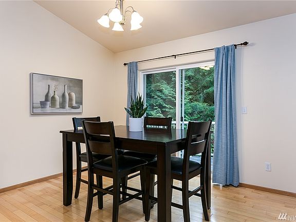 Dining area with slider to deck and the evergreen view.
