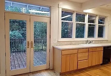 Portion of very large kitchen with French doors on to deck and back garden areas
