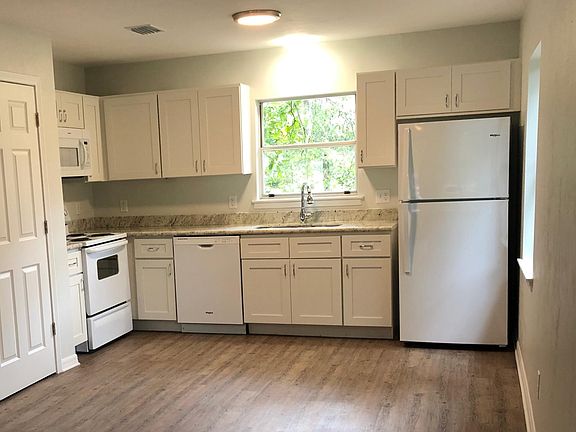 Kitchen. New appliances - fridge, stove, microwave, dishwasher. New cabinetry, and sink.