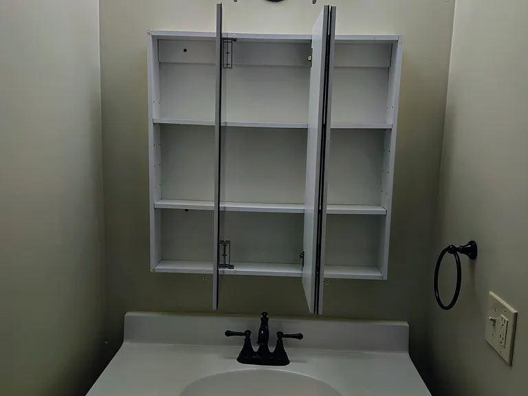 Extra Storage area behind mirror in bathroom.
