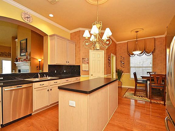 This open concept Kitchen also has a designer chandelier with ceiling medallion, large walk in pantry, a new stainless steel dishwasher, & granite back splash.
