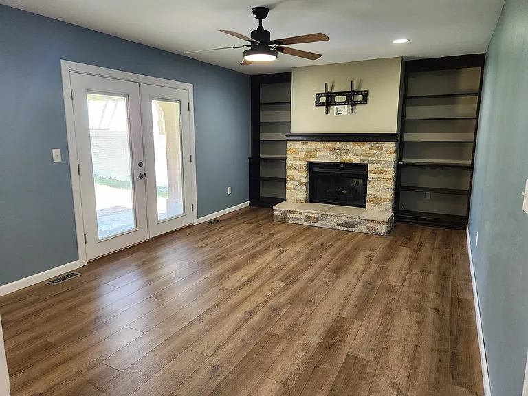 Hearth room with doors leading to backyard