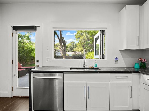 Kitchen with serving window overlooking the backyard