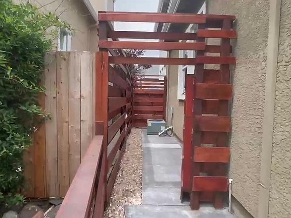 Side patio. A/C unit. Great to storage bicycles! Brand new fence.