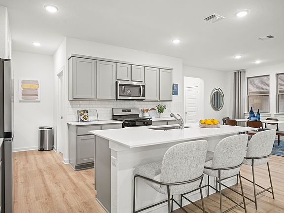 Kitchen in the Oak home plan by Trophy Signature Homes - REPRESENTATIVE PHOTO