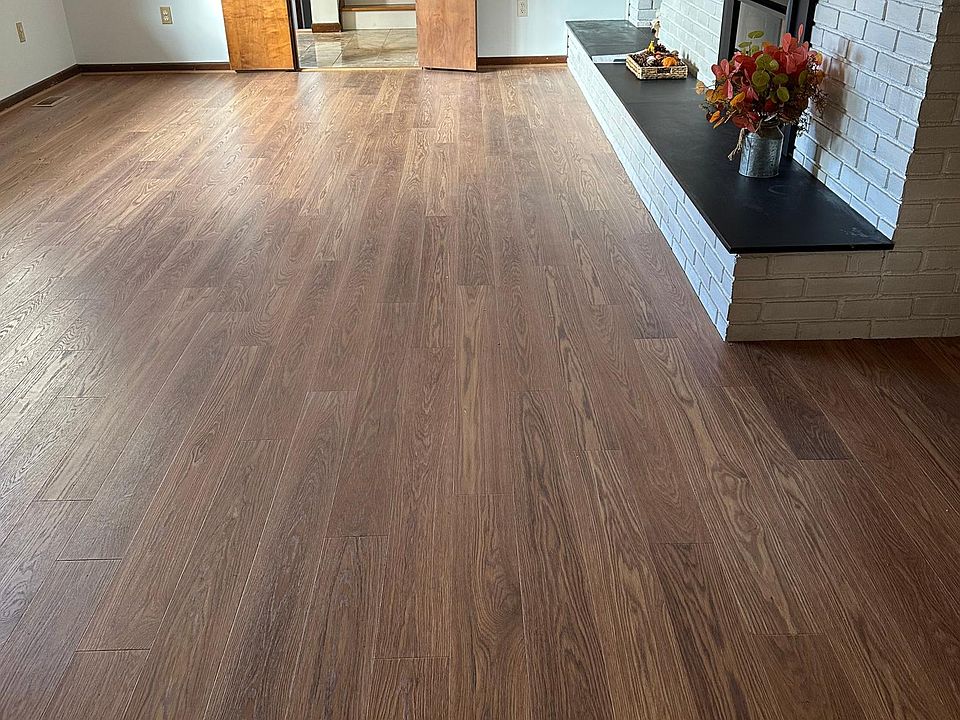 Family room with Newley installed wooden floor plus new electric remote control heater for the fireplace