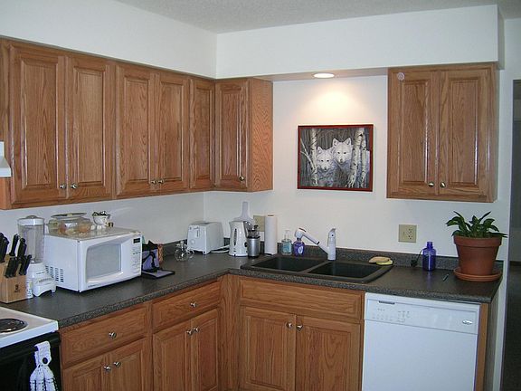 Kitchen has granite sink with granite look countertop.  DW, 