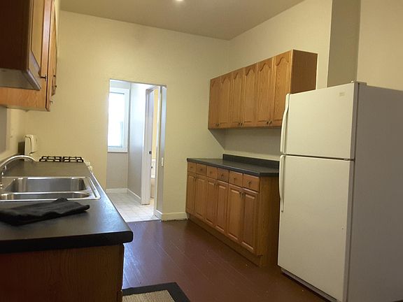 Kitchen and view to laundry area and main floor bathroom.