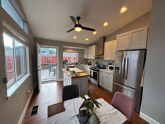 Kitchen view from living room, door into backyard