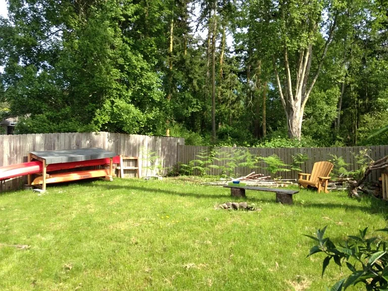This is the yard, it is fully fenced, with a fire pit.