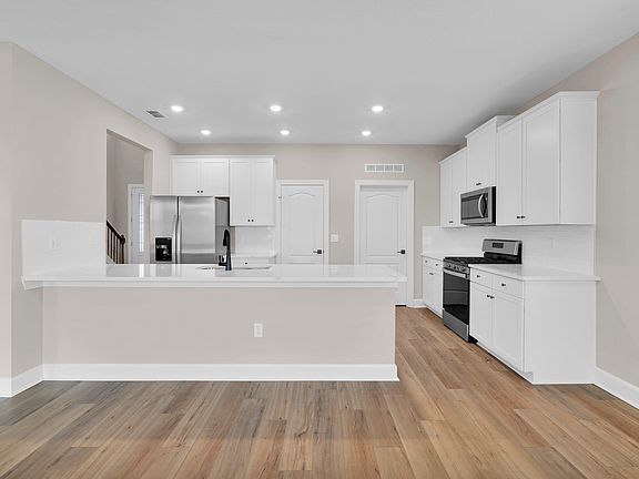 A roomy kitchen island provides perfect space for meal preparation, casual dinners or entertainment.