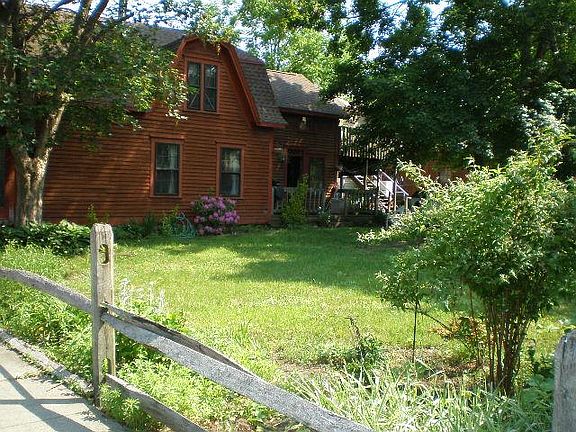 Front of house and view of yard and deck in the back.