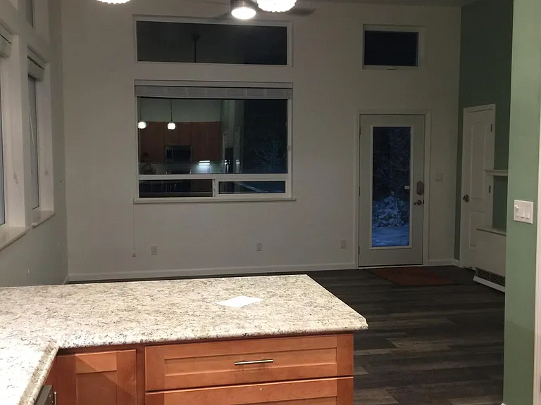 Kitchen looking into the living room and entryway.