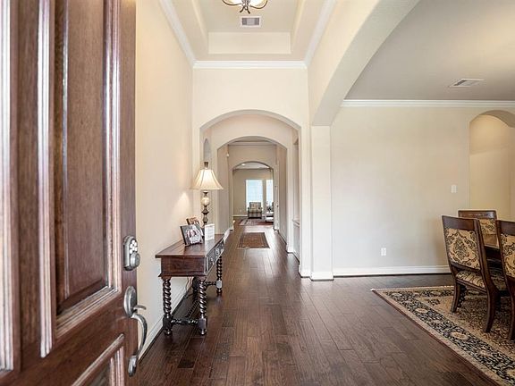 As you enter the beautiful home, you are delighted by elegant arches and recessed ceilings.